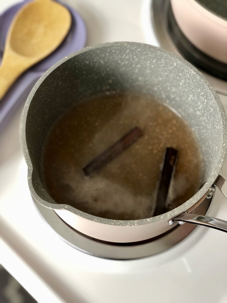 water and cinnamon sticks